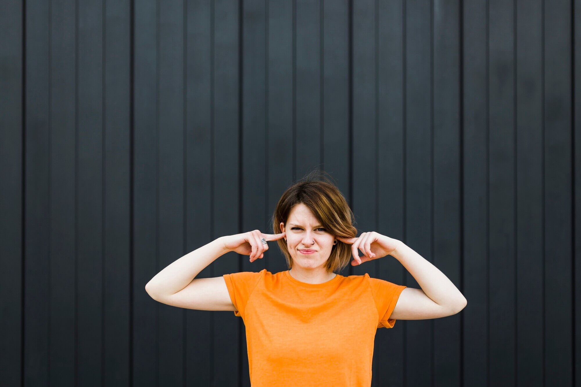 woman blocking hear ears - mrelectric